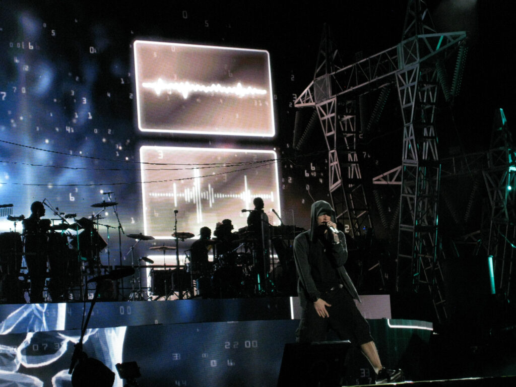 Eminem performing live onstage with a microphone