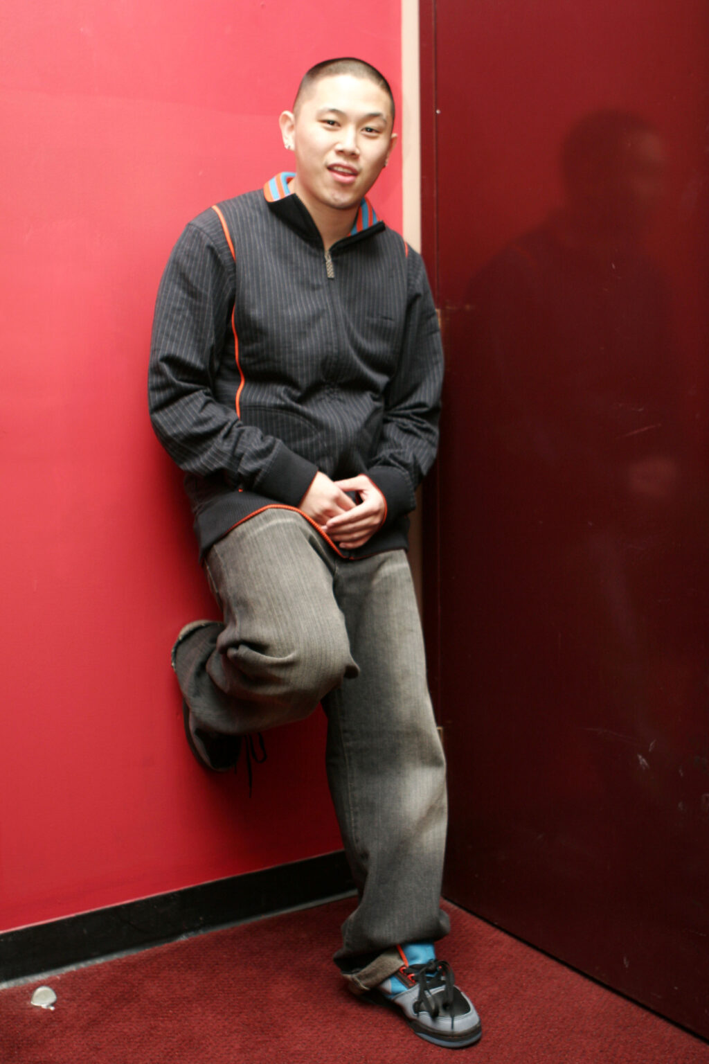 MC Jin performing onstage with a microphone