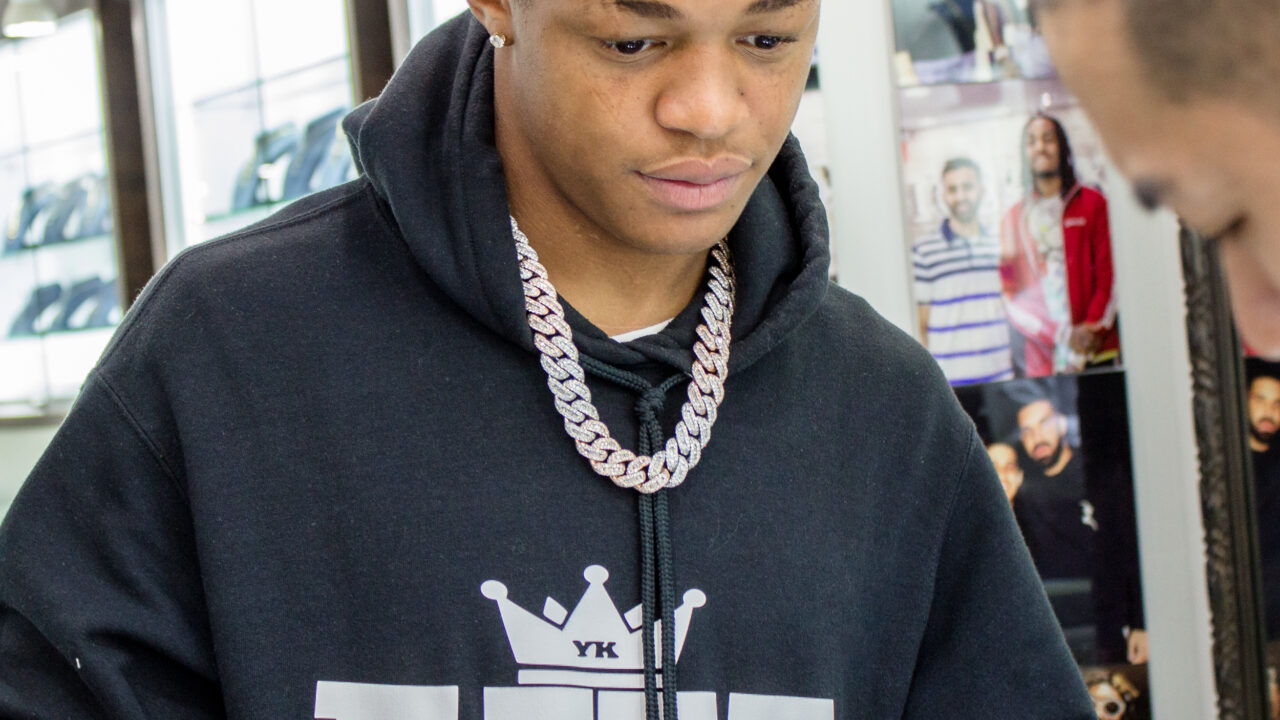 YK Osiris posing inside the Icebox jewelry store in 2019
