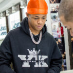 YK Osiris posing inside the Icebox jewelry store in 2019