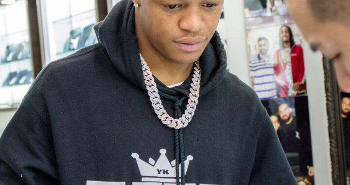 YK Osiris posing inside the Icebox jewelry store in 2019